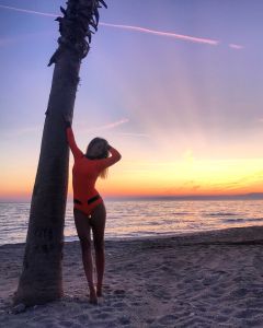 Alacati sunset. Model wearing orange Alooppa wetsuit